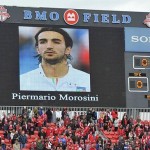 Toronto FC fans stand for a moment of silence in honor of Livorno's Morosini before MLS soccer match against Chivas USA in Toronto